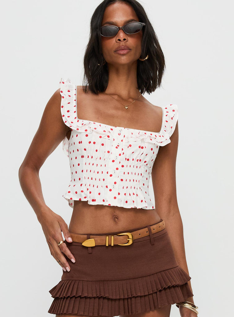 red top with white polka dots