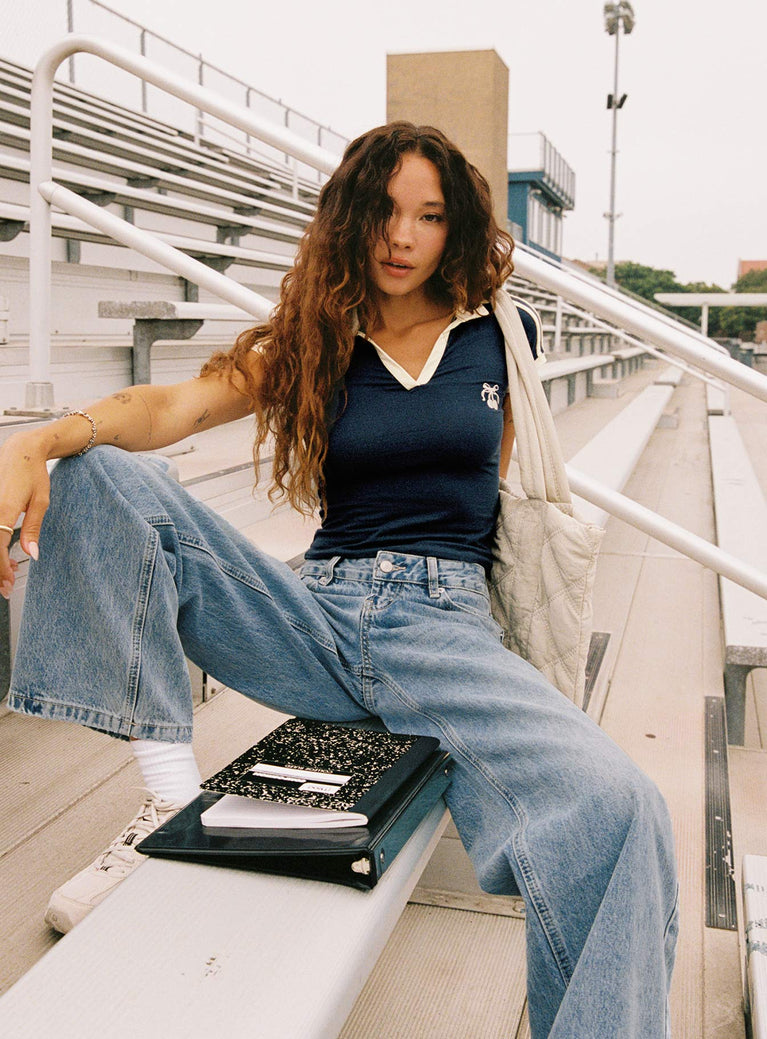 back view of model wearing Princess Polly Serenitia Mid Rise Relaxed Jeans Light Wash Mid Rise