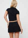 back view of model wearing Princess Polly Gigi Skort Black Lower Impact Low Rise Shorts