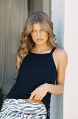 woman leaning against a corner