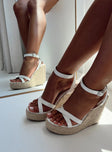 Woven base  Faux leather upper Strappy upper  Bucket fastening at ankle  Wedge heel  Platform base 