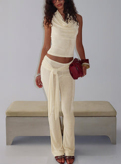 side view of model wearing Princess Polly Butterfly Tie Detail Pants Lemontini Mid Rise Pants 