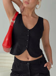 Vest top V-neckline, button fastening at front, split hem Non-stretch material, partially lined