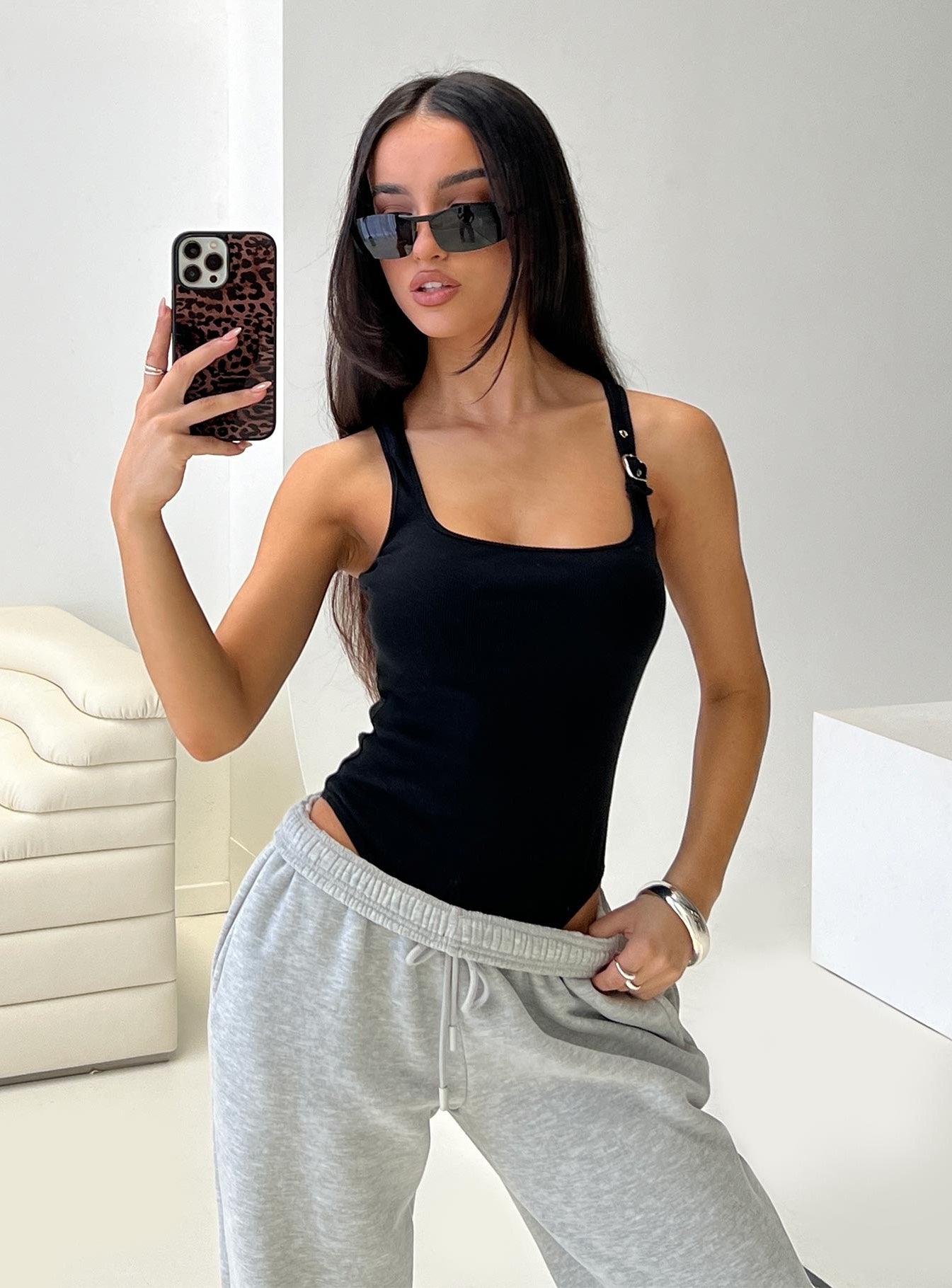 side view of model wearing Princess Polly Novelle Bodysuit Black Sleeveless Square Neck 