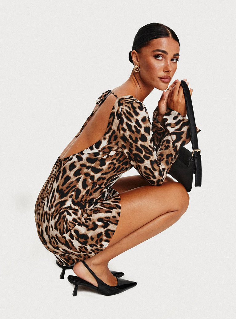 Leopard print Mini dress  High wide neckline, long slight flared sleeves, curved hem, open low back, back neck tie fastening, invisible zip fastening at back 