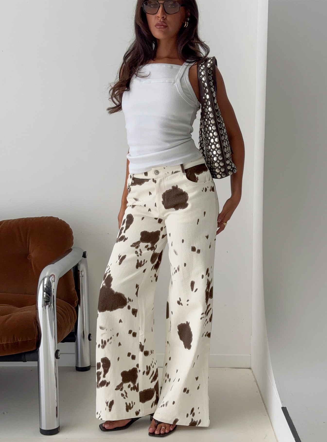 front view of model wearing Princess Polly Big Dreamer Low Rise Straight Leg Jeans Cow Print Low Rise Jeans 