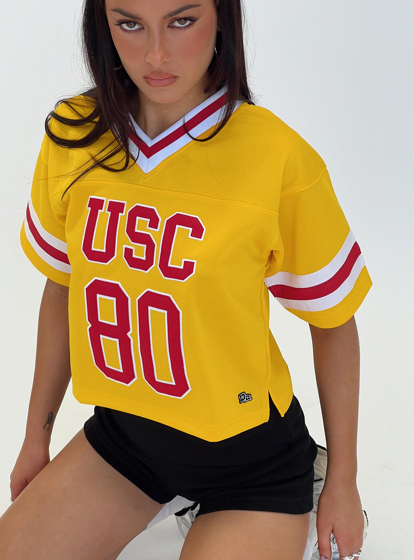 front view of model wearing Princess Polly USC Football Jersey Gold Half Sleeves V-Neck 
