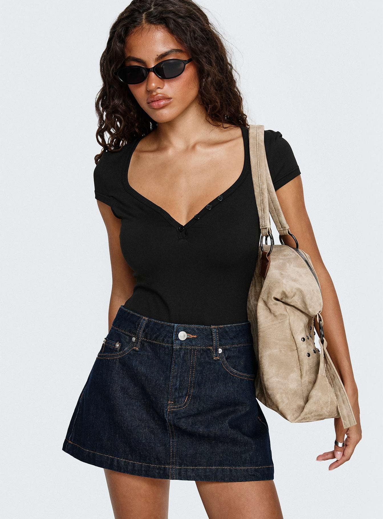   front view of model wearing Princess Polly Nicolina Low Rise Denim Mini Skirt Raw Denim Mini Skirts 