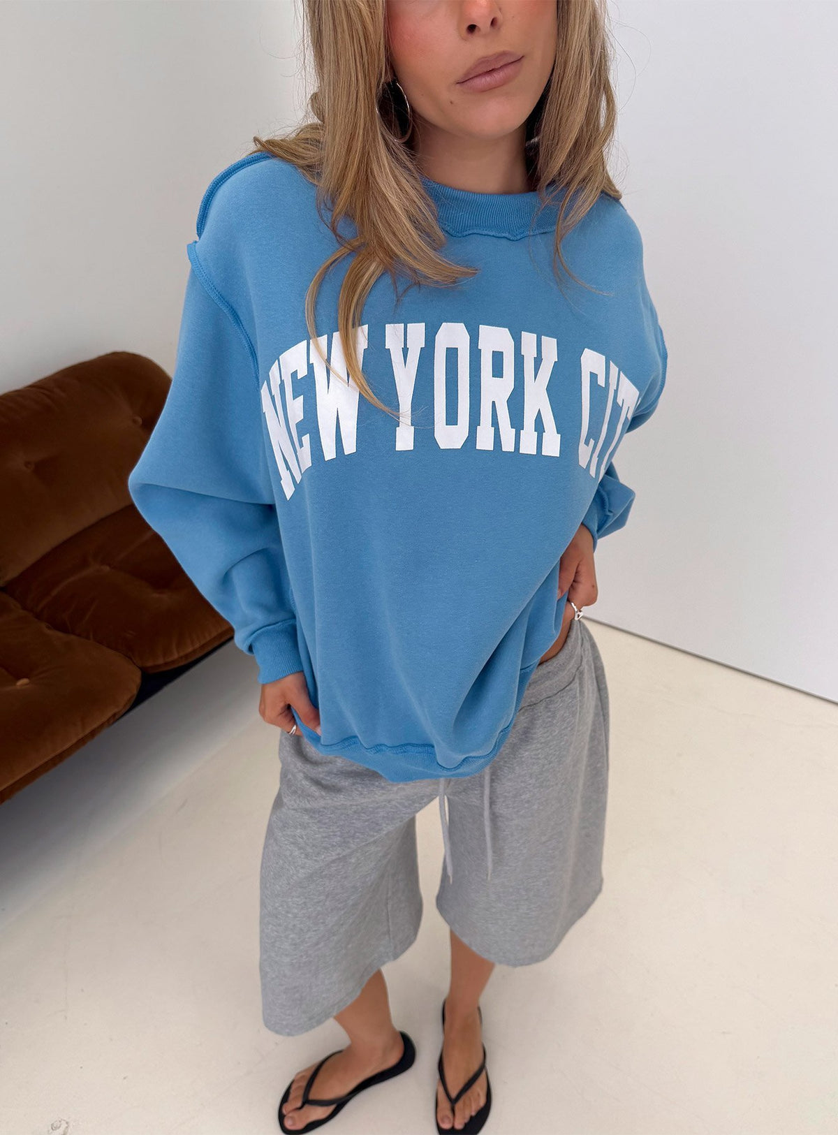 Showcasing the When In New York City Oversized Jumper Blue womens jumper in long fit front view of model wearing Princess Polly