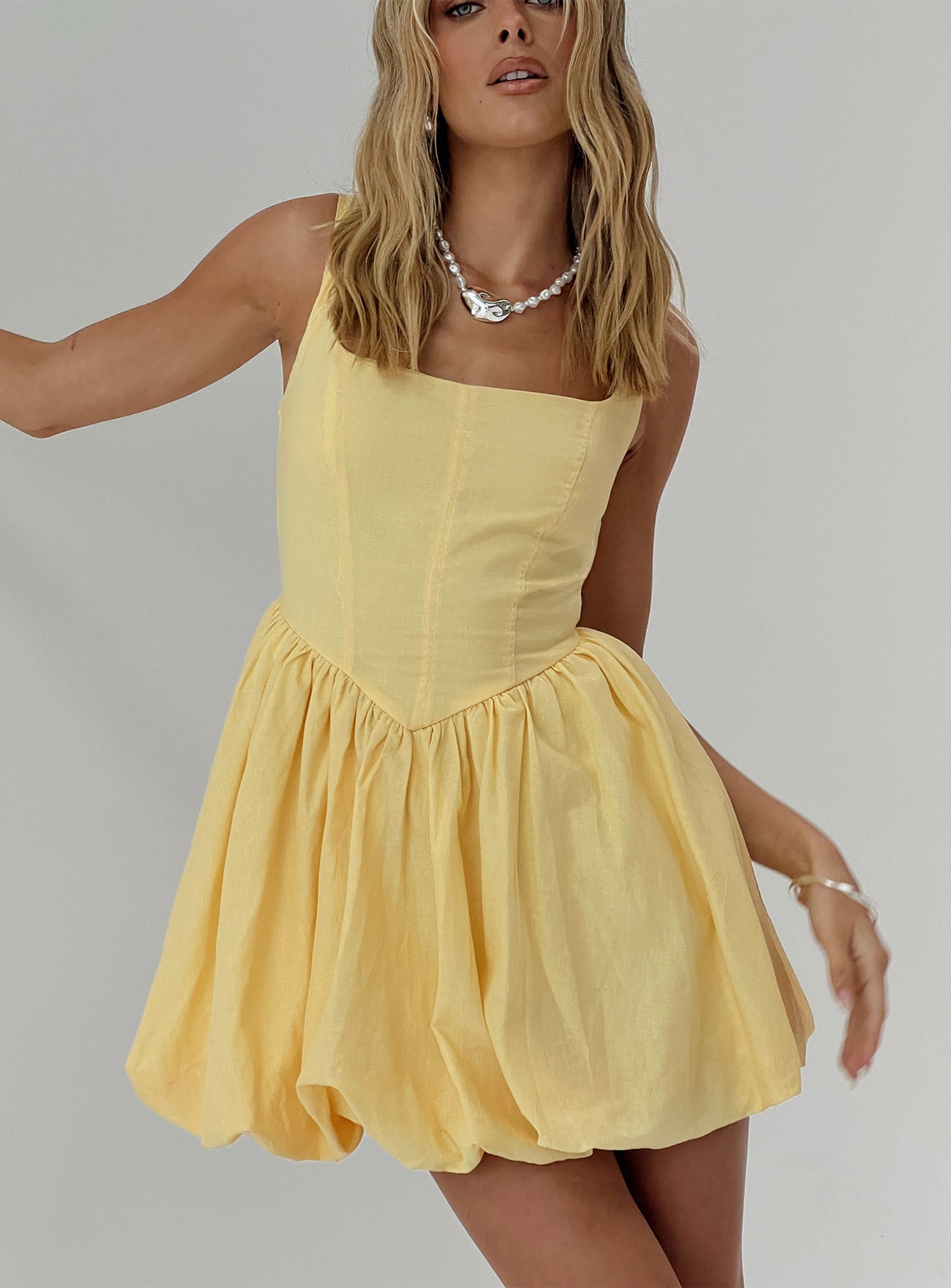 front view of model wearing Princess Polly Alcott Bubble Hem Mini Dress Lemon Square Neck 