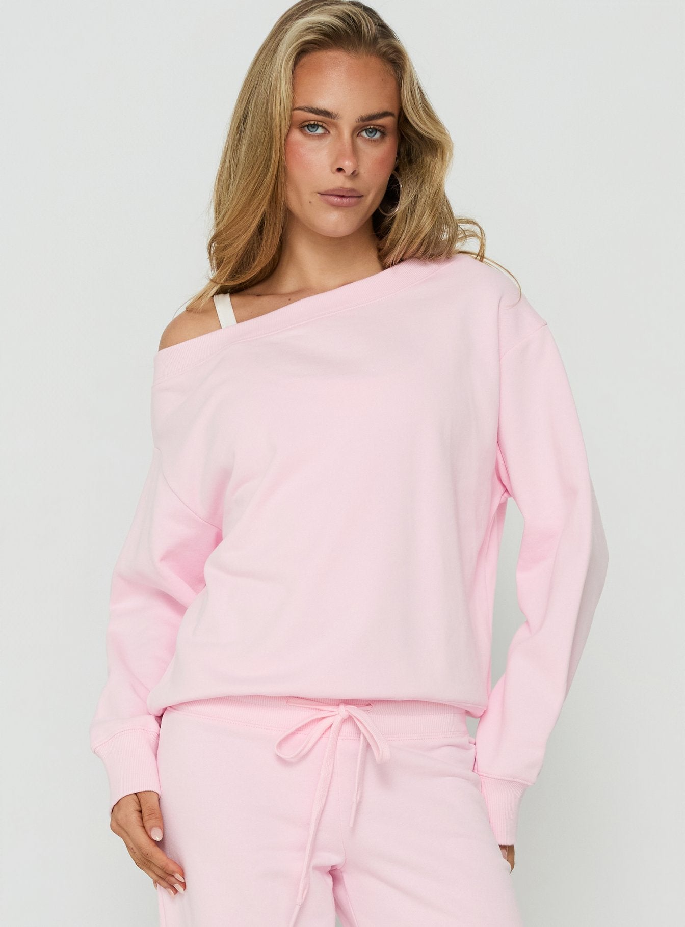 Discover the Wellness Off The Shoulder Jumper Pink womens-jumpers with short length front view of model wearing Princess Polly