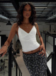 front view of model wearing Princess Polly Junia Top White Sleeveless V-Neck 