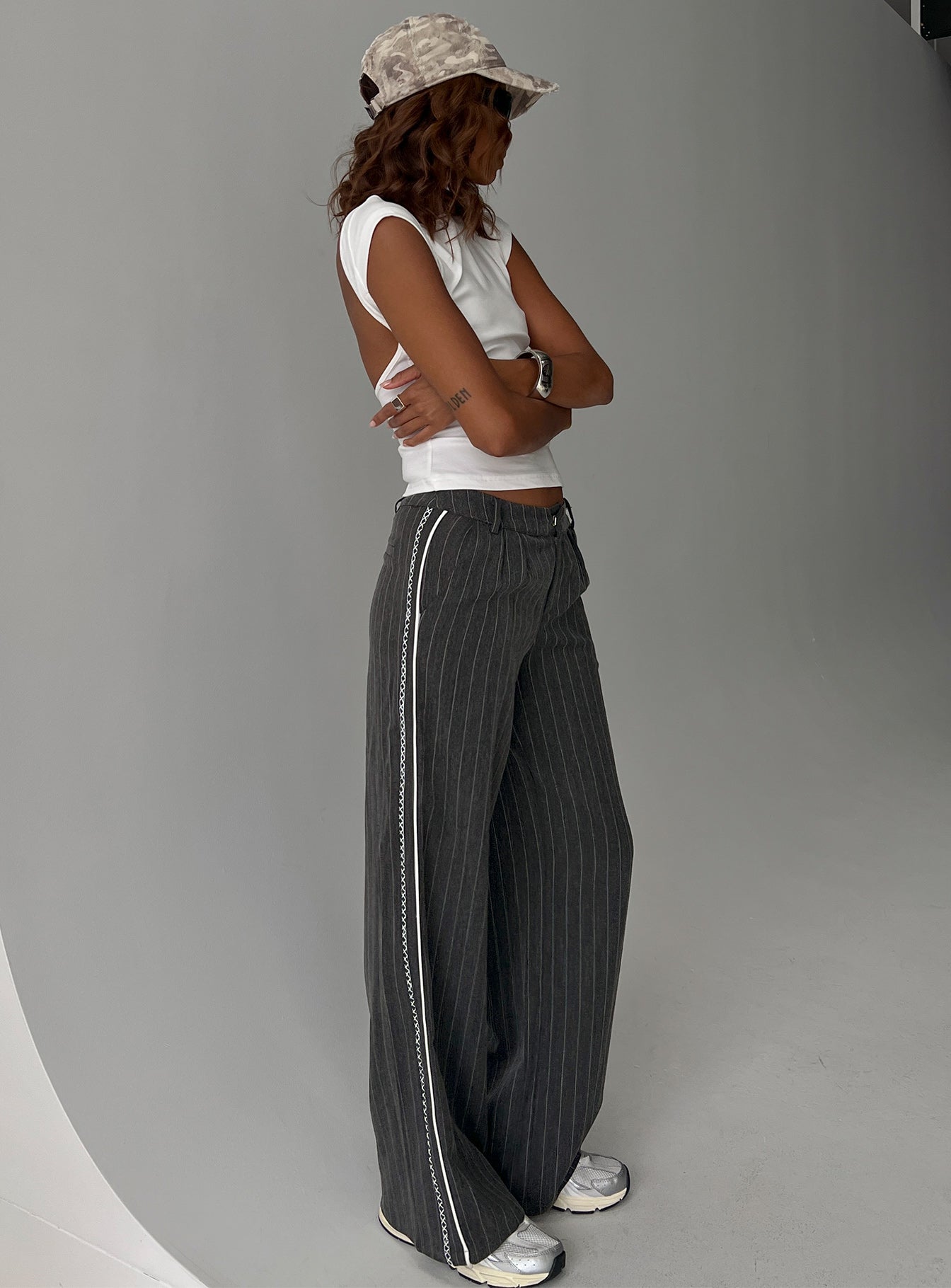back view of model wearing Princess Polly Knowla Pleated Trouser Pant Grey Pinstripe Mid Rise Pants 