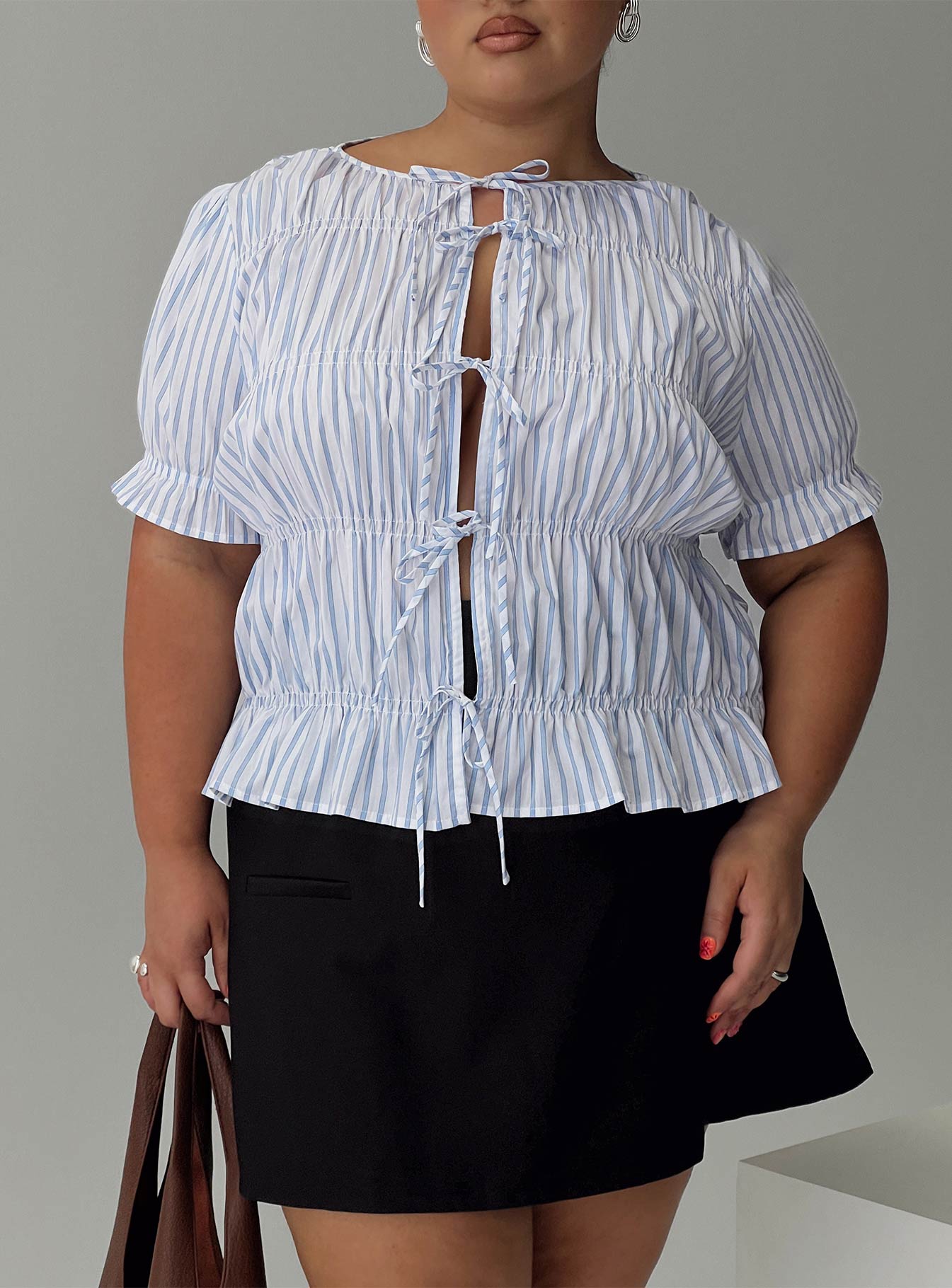 front view of model wearing Princess Polly Alistair Bow Tie Top Blue / White Stripe Curve Half Sleeves Crew Neck 