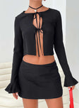 Top Long sleeves with ruffle cuff, sheer material, open front  Tie fastenings at front 