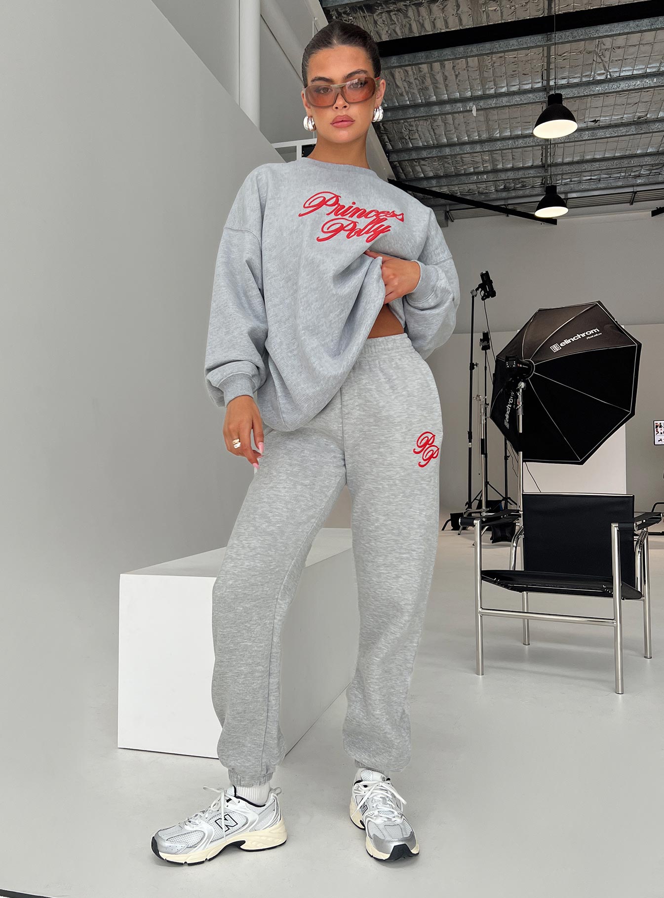 front view of model wearing Princess Polly Princess Polly Track Pants Cursive Text Grey Marle/ Red High Waisted Pants 