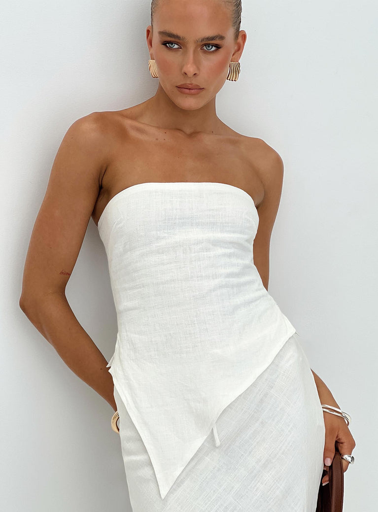 White Strapless linen top Inner silicone strip at bust, invisible zip fastening at side, asymmetrical pointed hem