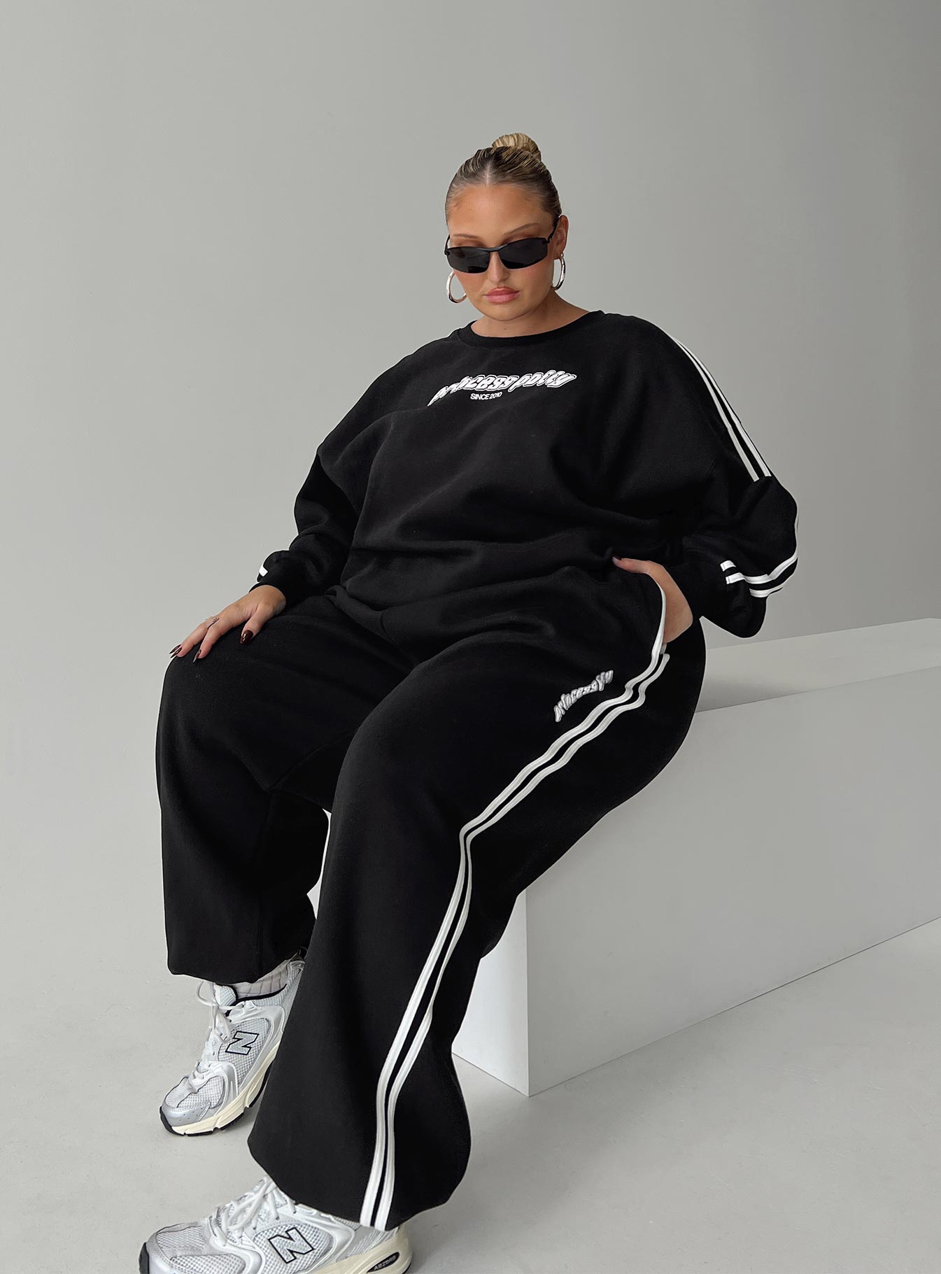 front view of model wearing Princess Polly Princess Polly Track Pants Stripe Black / White Curve High Waisted Pants 