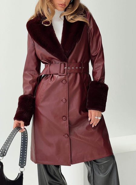 Longline coat Faux leather material, faux fur trimming, button front fastening, twin pockets at sides, removable waist belt