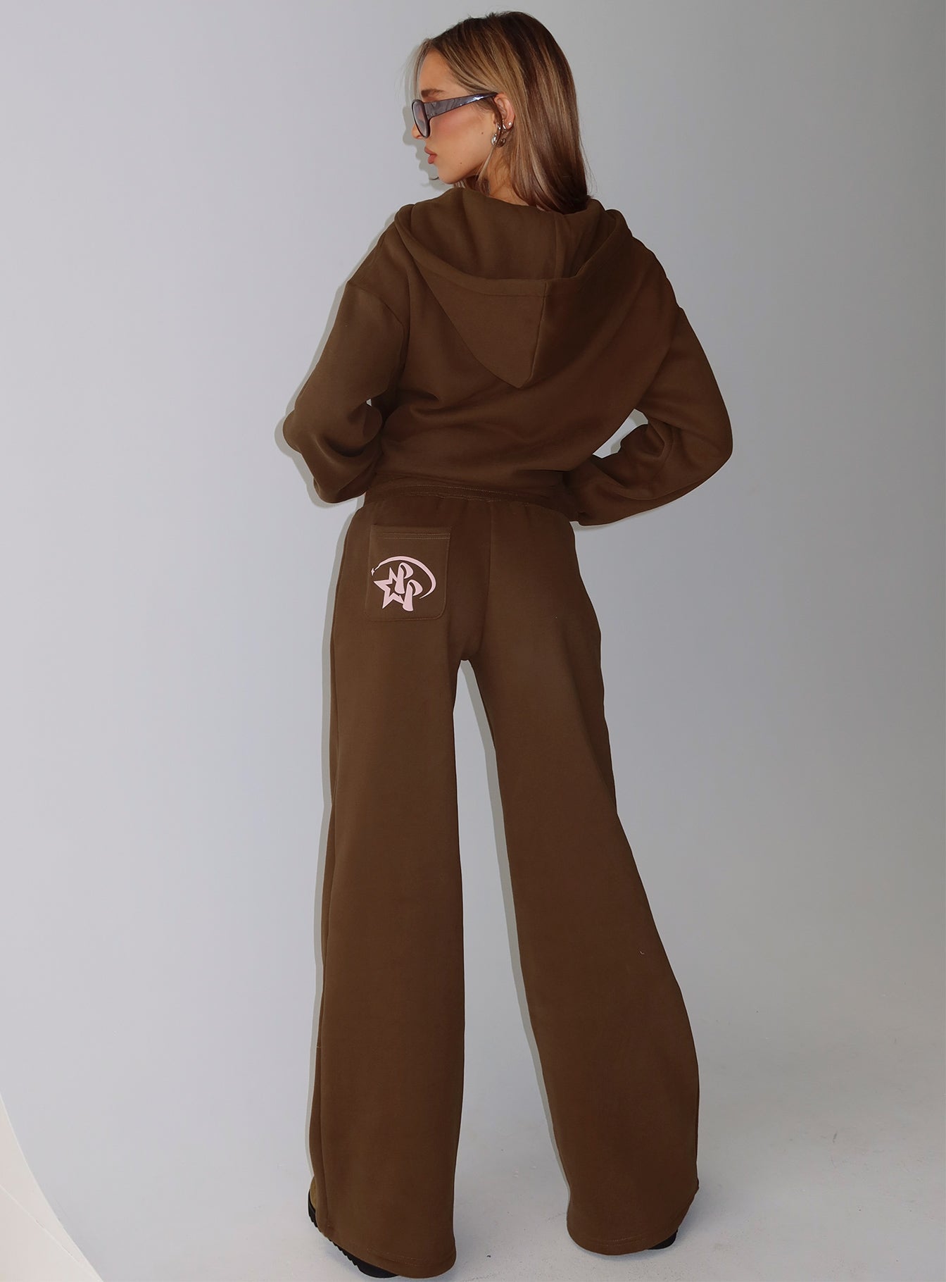 back view of model wearing Princess Polly Princess Polly Stargirl Wide Leg Sweat Pants Brown High Rise Pants 