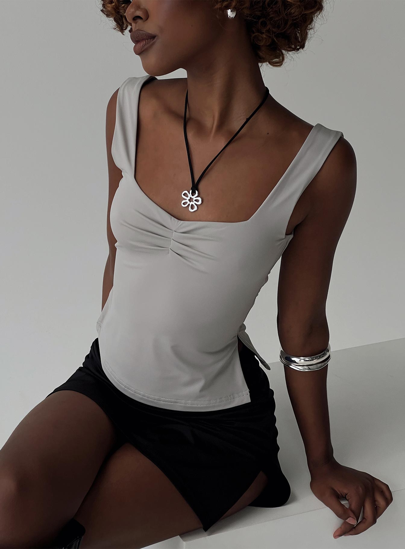 side view of model wearing Princess Polly Rehna Top Grey Sleeveless V-Neck 