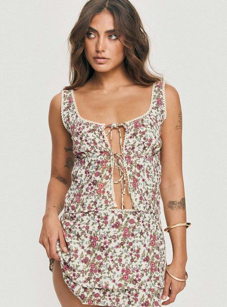 Floral print crop top Fixed shoulder straps, scooped neckline, twin tie fastening at bust, split hem Non-stretch material, unlined 
