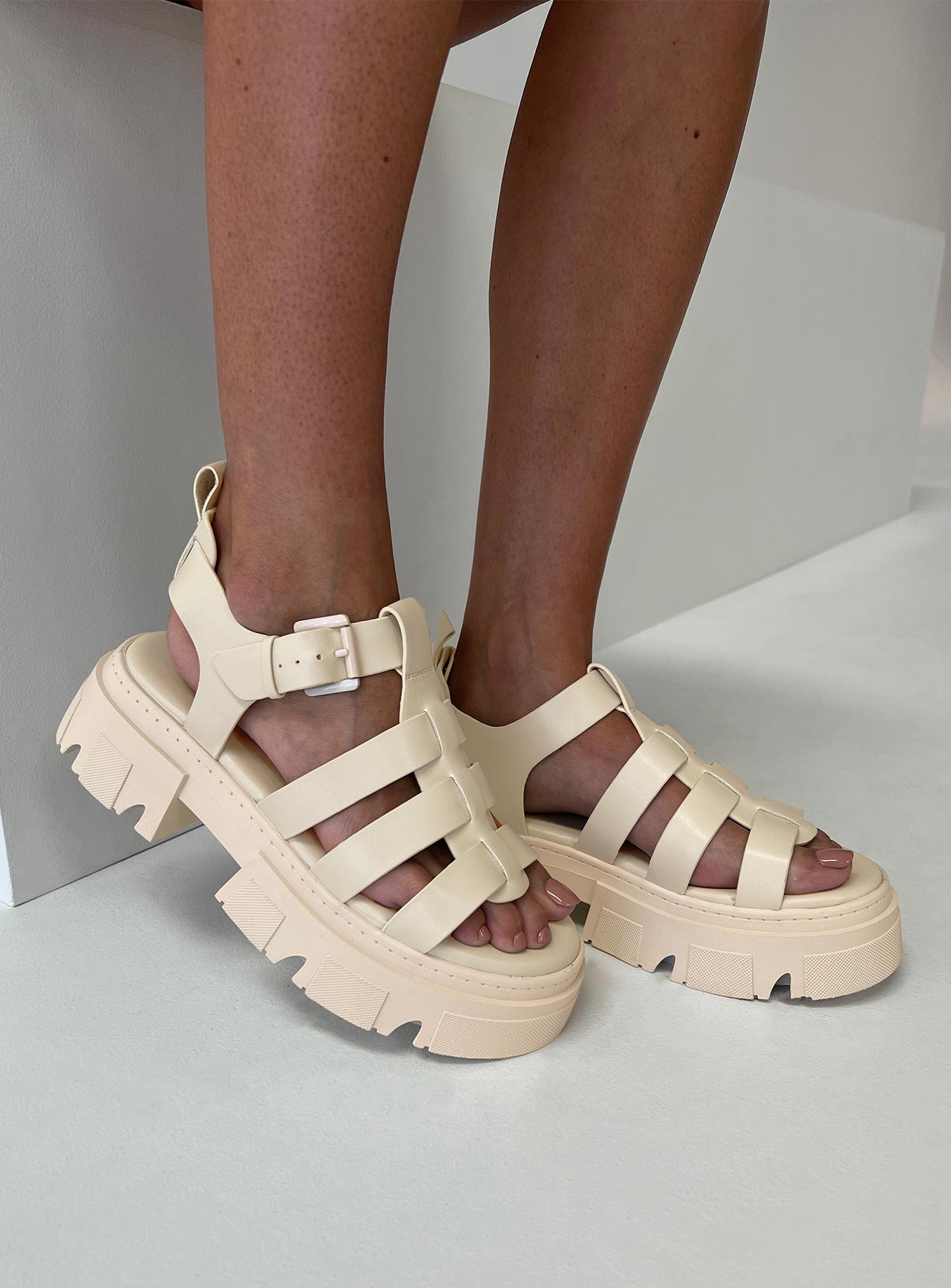 Strappy sandals Rounded toe, strappy upper, buckle fastening at ankle, platform base, treaded sole