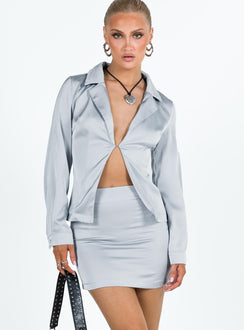 Matching set Silky material Long sleeve shirt Lapel collar Plunging neckline Single hook and eye fastening at front Single button cuff Split hem Mini skirt Invisible zip fastening at side