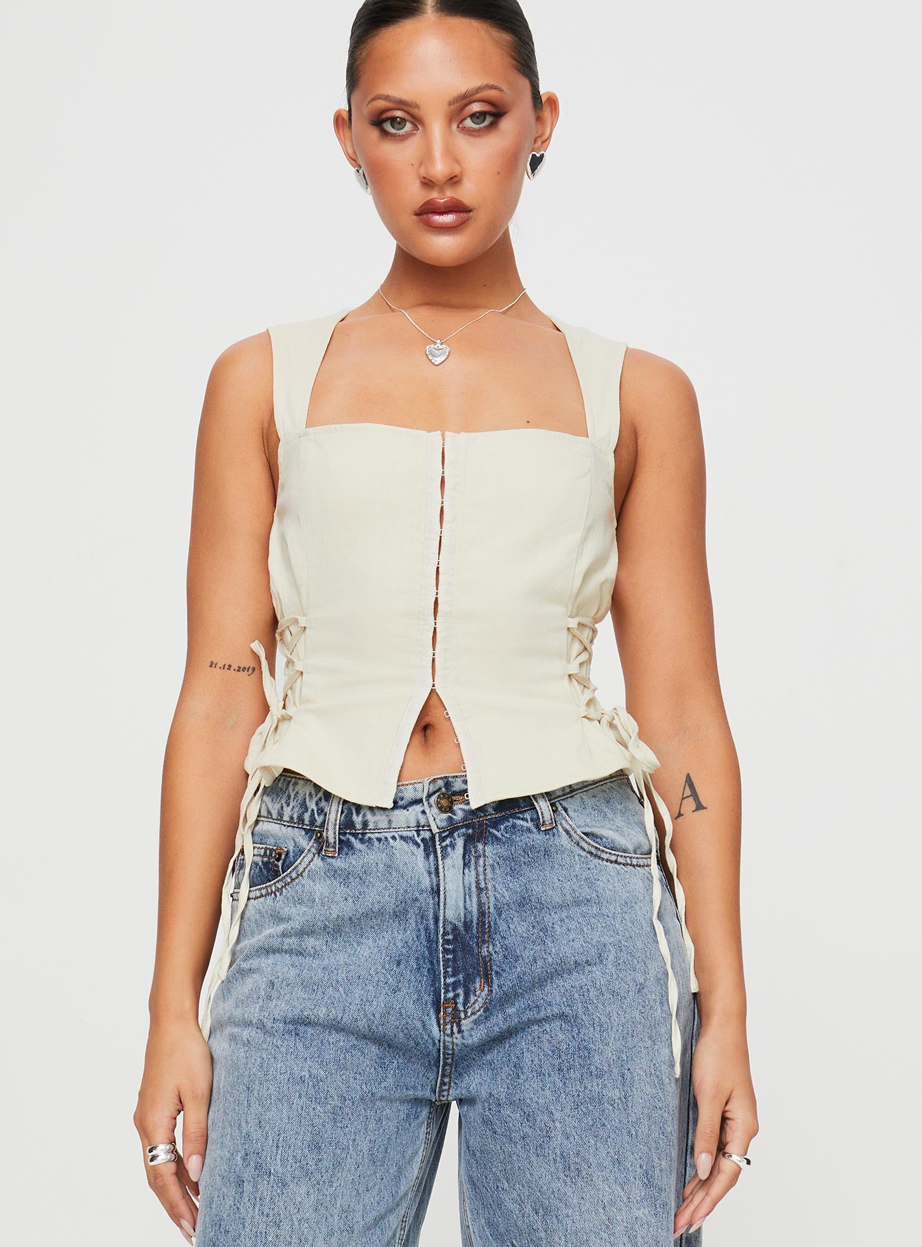 Front view of model wearing  front Princess Polly Sleeveless Square Neck  Myrin Top Beige