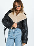 Cropped jacket Faux leather material Oversized collar Removable belts at waist and cuff Buckle fastening 