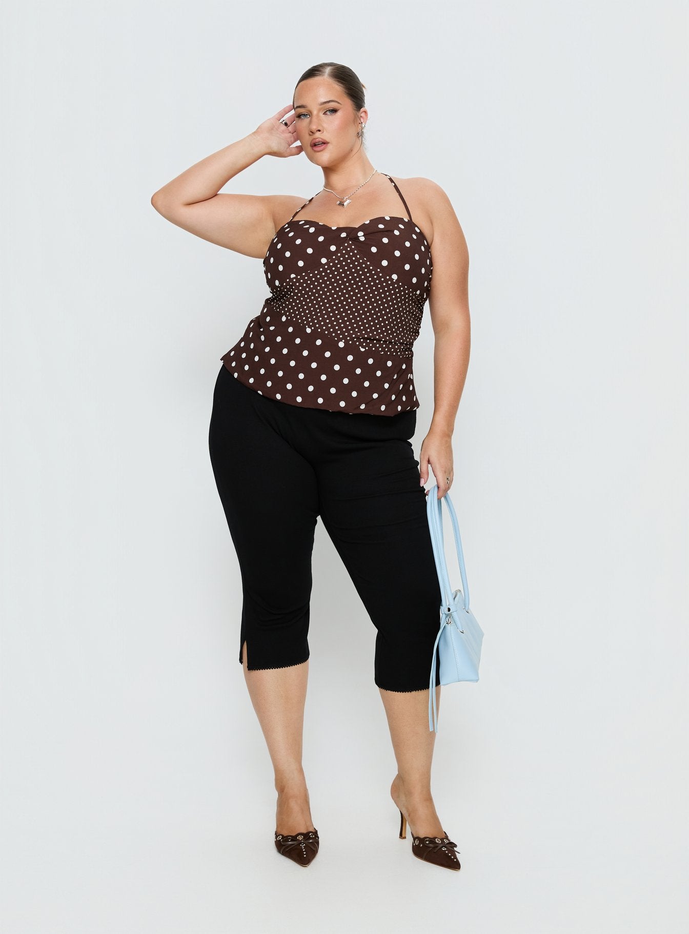 back view of model wearing Princess Polly Baseline Rib Capri Pants Black Curve Mid Rise Pants 