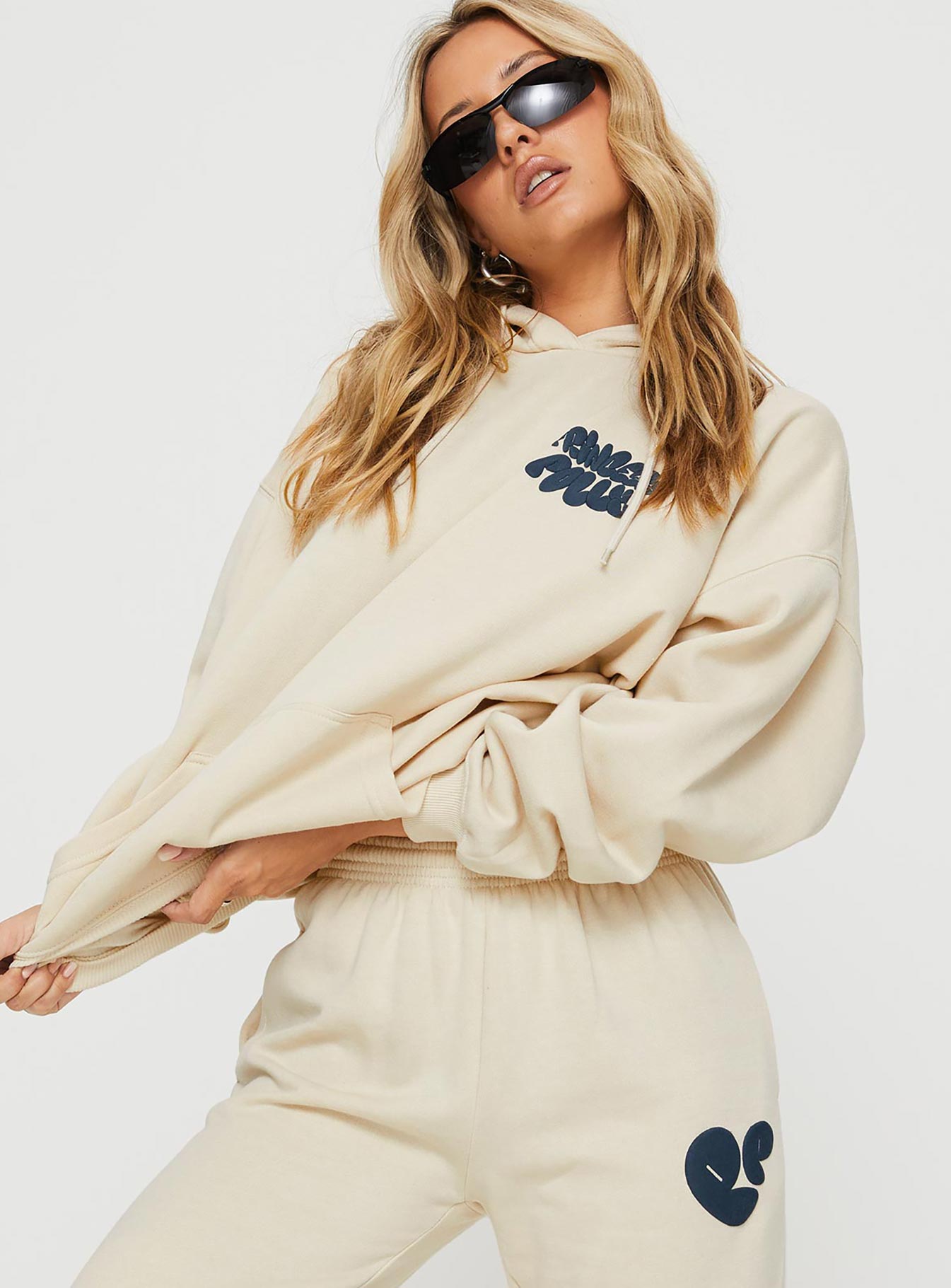 side view of model wearing Princess Polly Princess Polly Hooded Sweatshirt Bubble Text Stone / Slate Long 