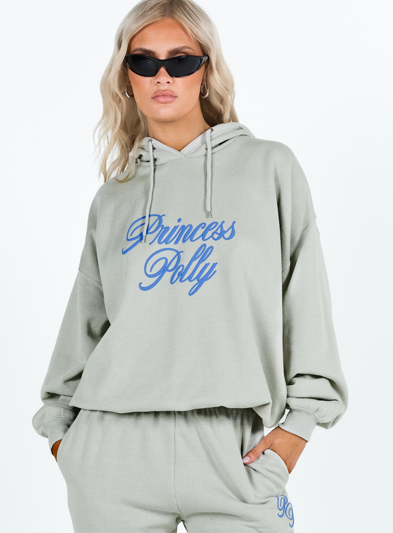 front view of model wearing Princess Polly Princess Polly Hooded Sweatshirt Cursive Text Grey / Blue regular 