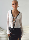 Long sleeve top Sheer material V neckline Lace trim Twin tie fastening at bust