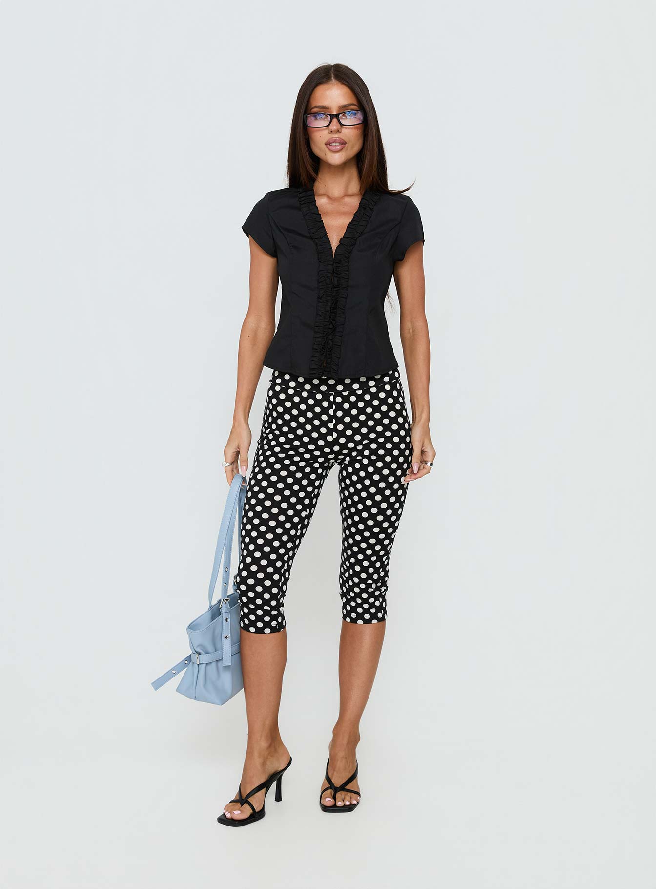 front view of model wearing Princess Polly Isadonna Capri Pants Black Polka Dot Mid Rise Pants 