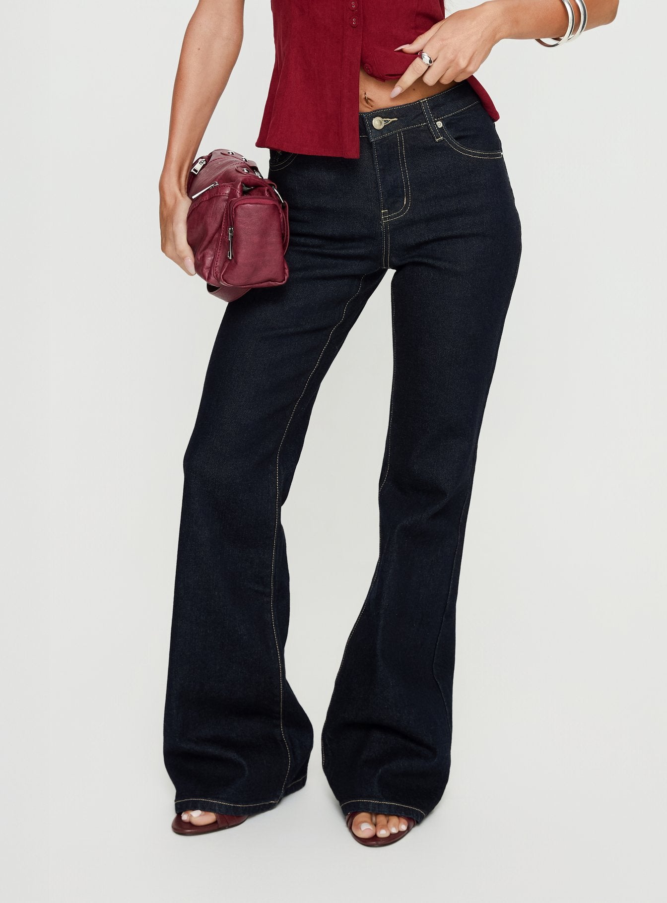 side view of model wearing Princess Polly Magic Mirror Mid Rise Bootleg Jeans Raw Indigo Mid Rise Jeans 