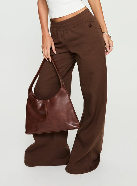 back view of model wearing Princess Polly Summits Flared Track Pants Chocolate High Rise Pants 