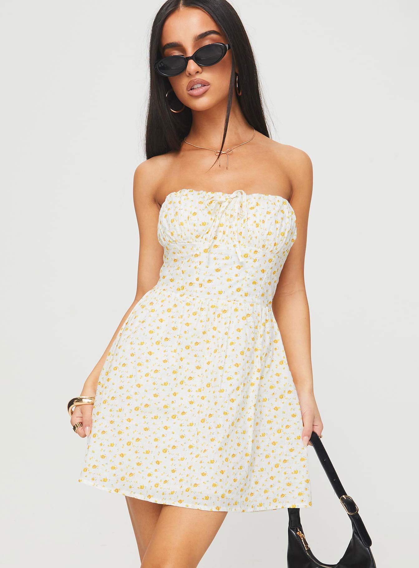 side view of model wearing Princess Polly Calidora Strapless Mini Dress Orange Floral Straight Neck 