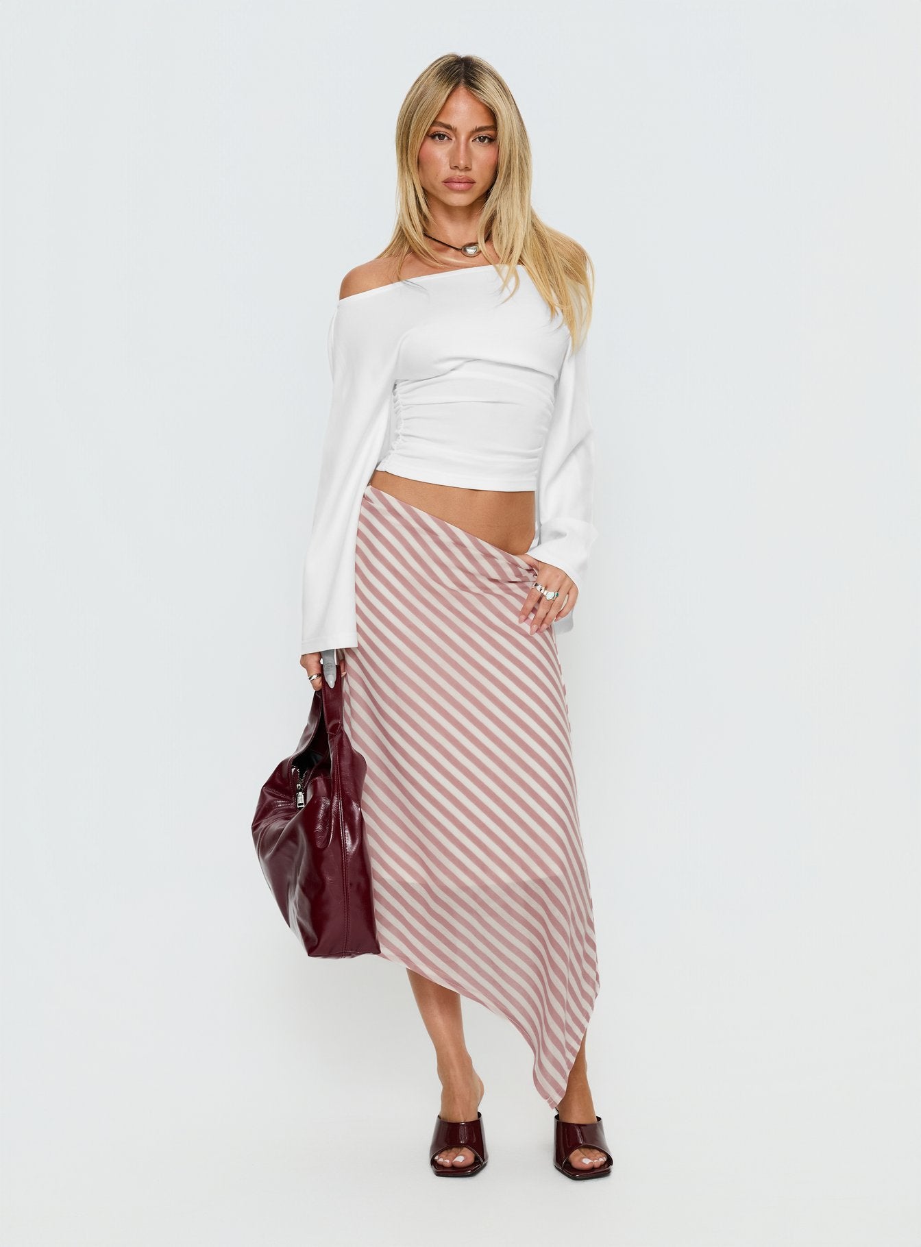   side view of model wearing Princess Polly Gwenora Asymmetrical Midi Skirt Pink Stripe Midi Skirts 