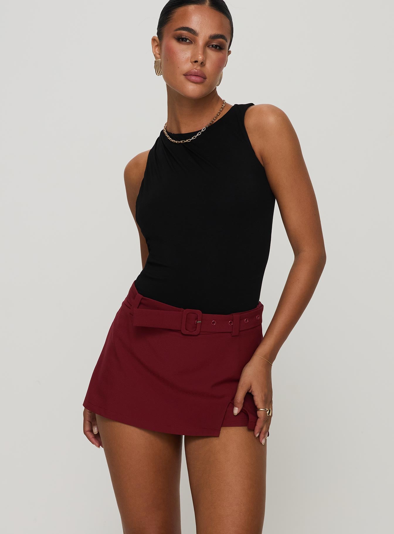 side view of model wearing Princess Polly Centre Stage Cut Out Bodysuit Black Sleeveless 