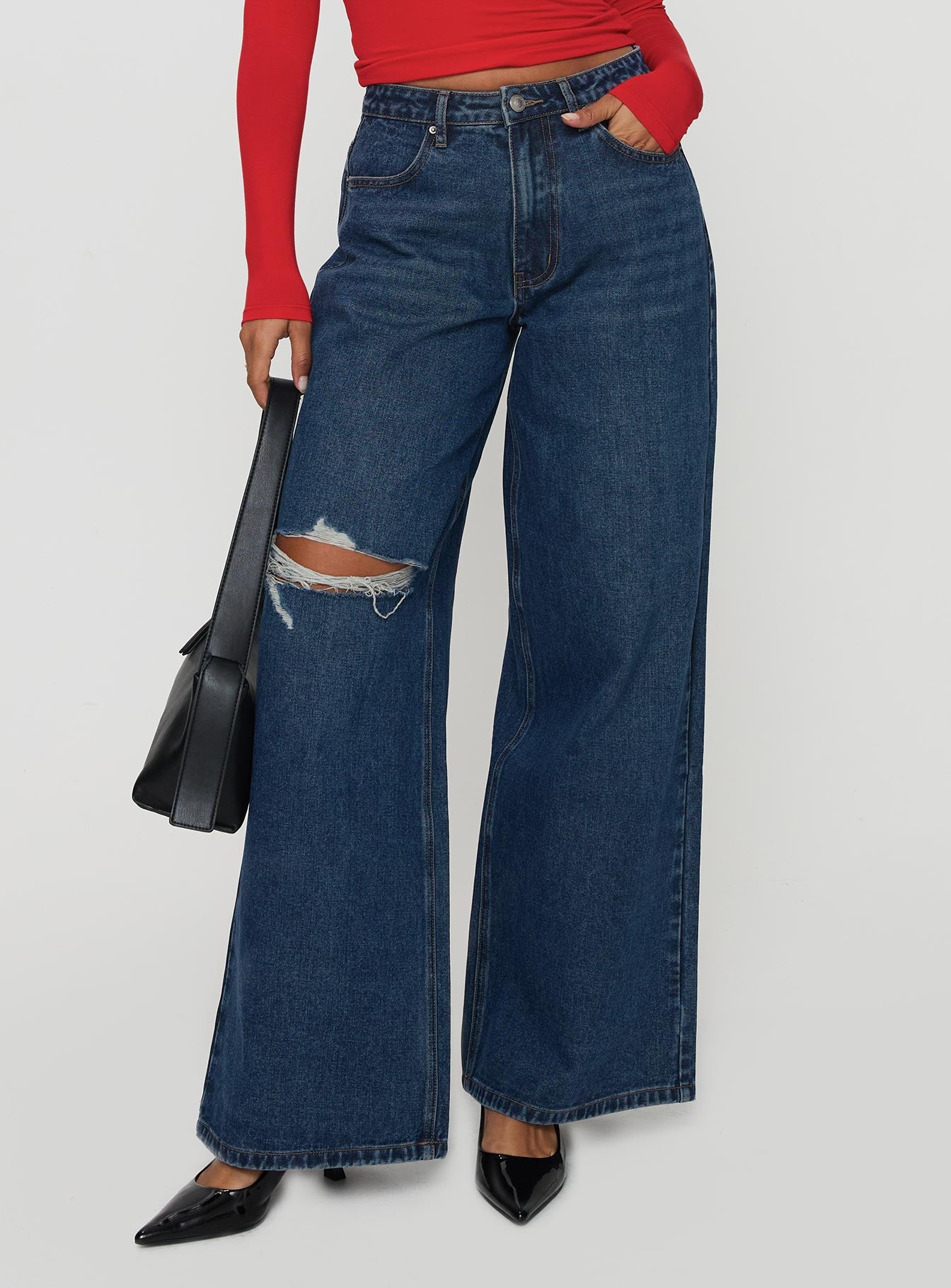 side view of model wearing Princess Polly Naylor Rip Wide Leg Jeans Dark Blue Wash Mid Rise 