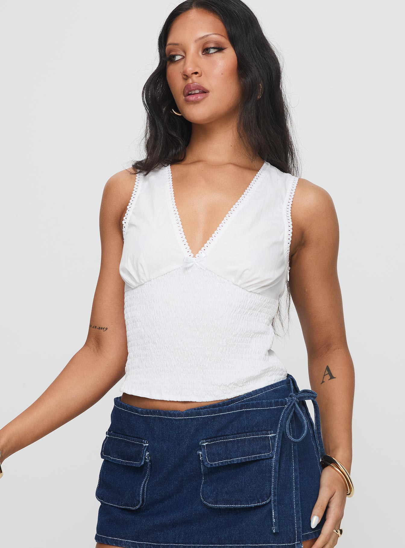 side view of model wearing Princess Polly Hevalis Top White Sleeveless V-Neck 