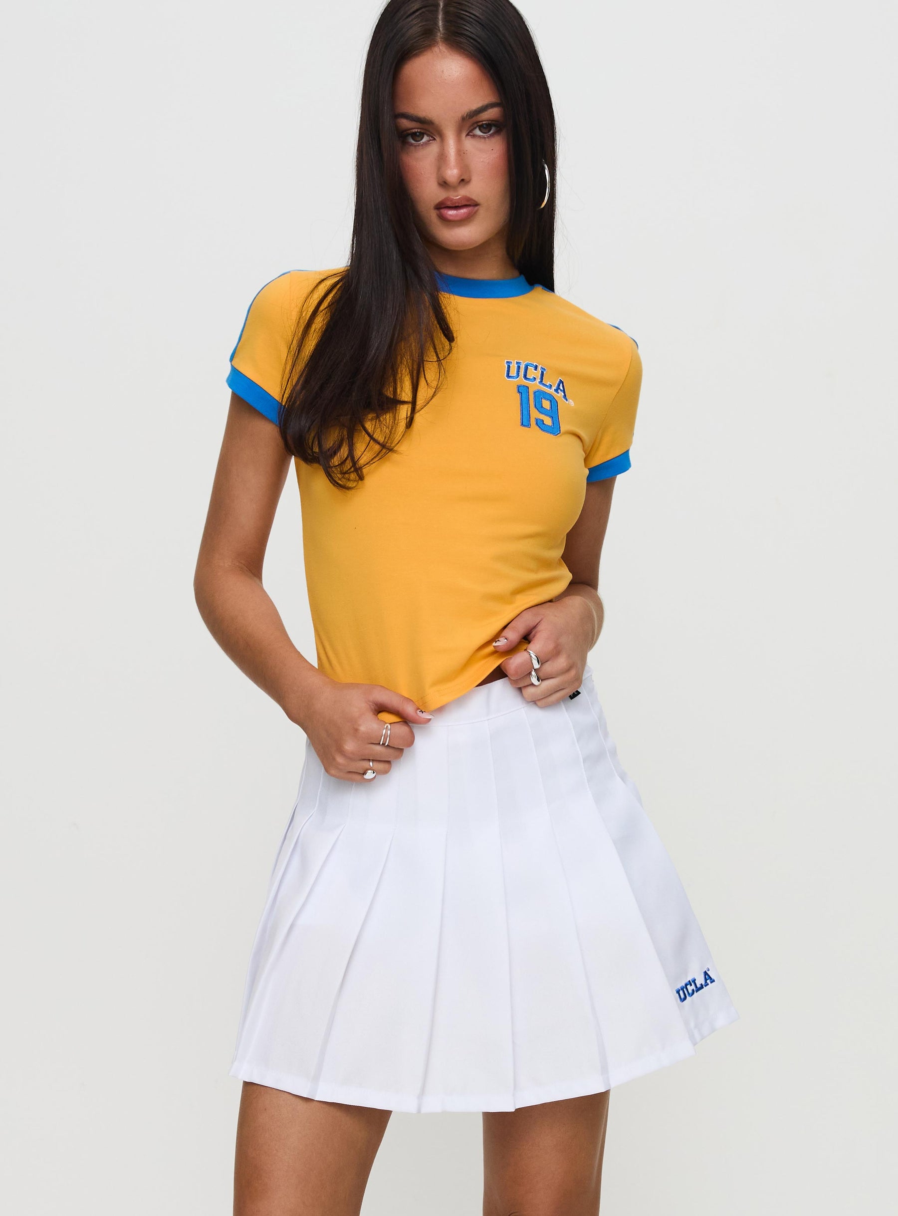  front view of model wearing Princess Polly UCLA Tennis Skort White 