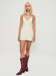 Romper V neckline, adjustable straps, open back with cross-over detail, tie fastening Non-stretch material, fully lined 