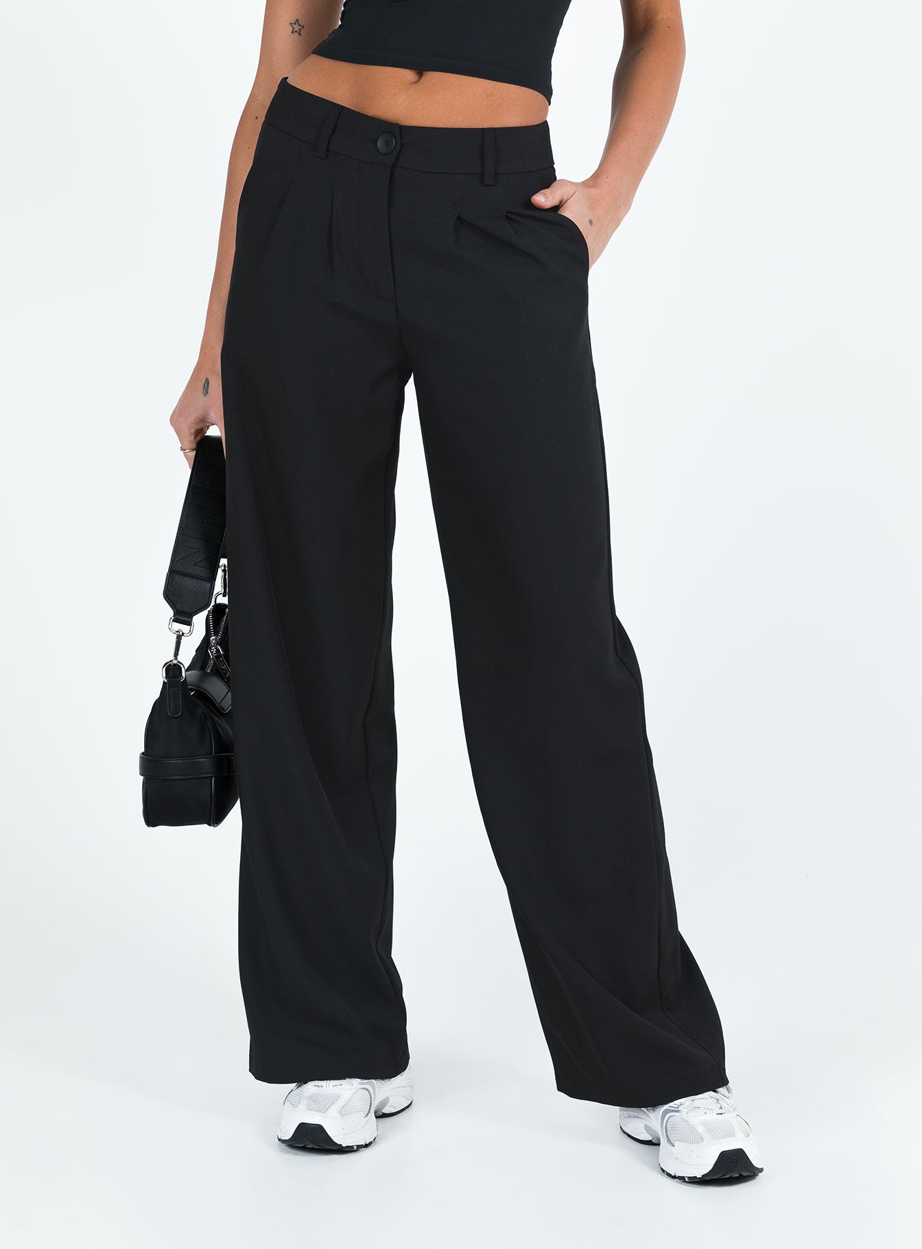 front view of model wearing Princess Polly Archie Low Rise Pants Black Tall Mid Rise 