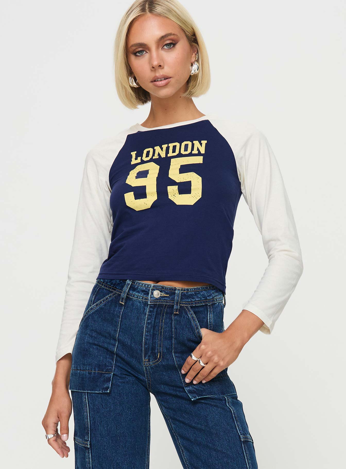 front view of model wearing Princess Polly London 95 Long Sleeve Top Navy Full Sleeves Crew Neck 