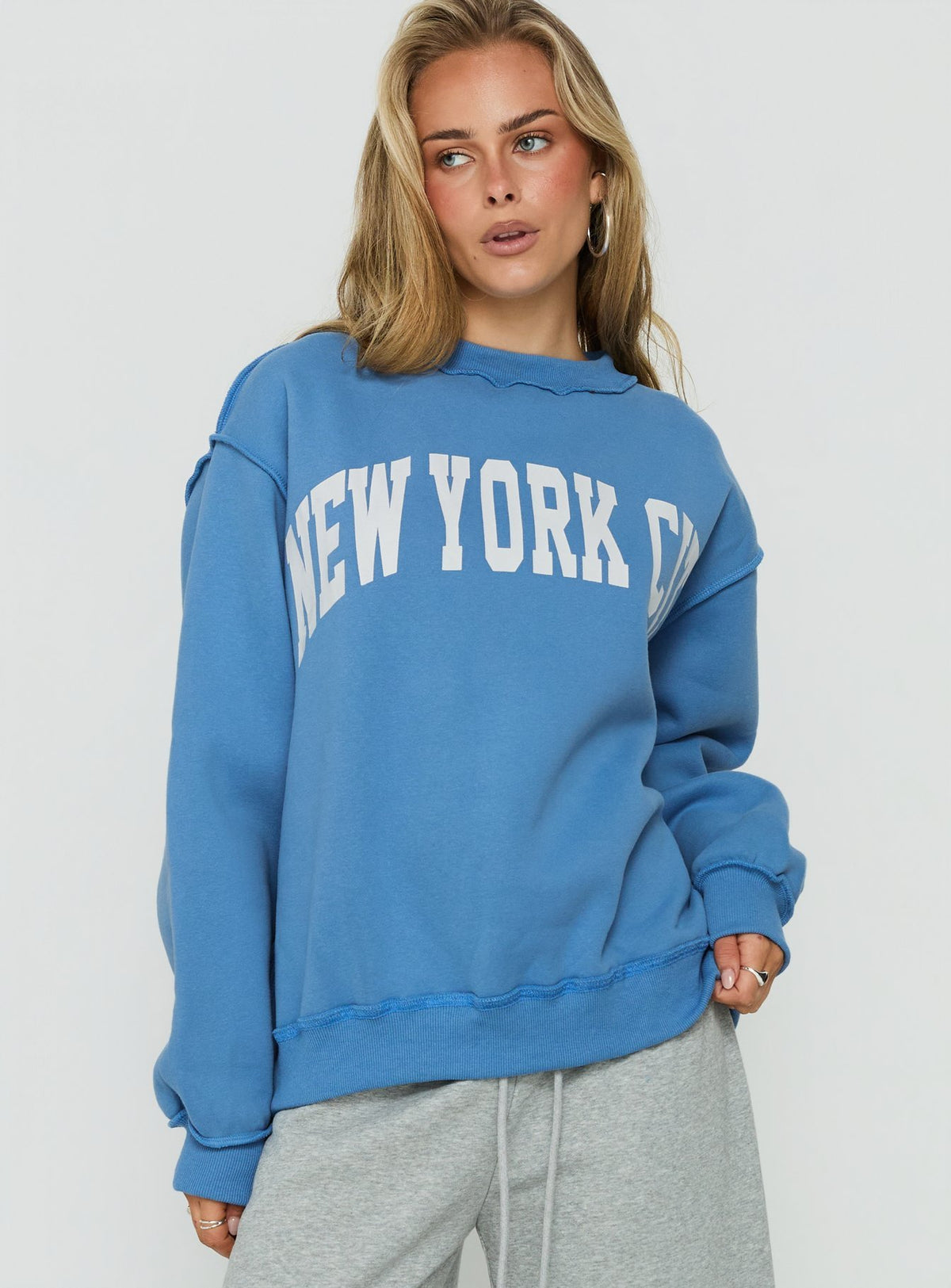 Discover the When In New York City Oversized Jumper Blue womens jumper with long fit detail view of model wearing Princess Polly