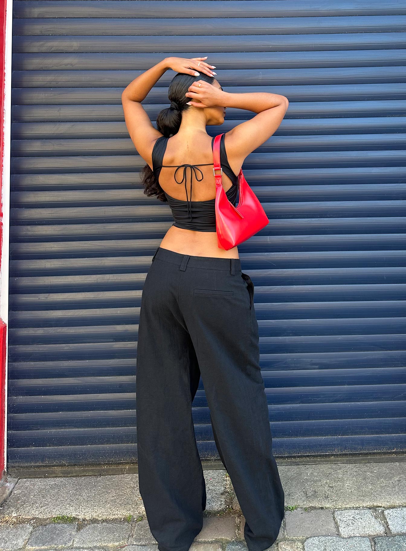 back view of model wearing Princess Polly Unwind Top Black Sleeveless Square Neck 