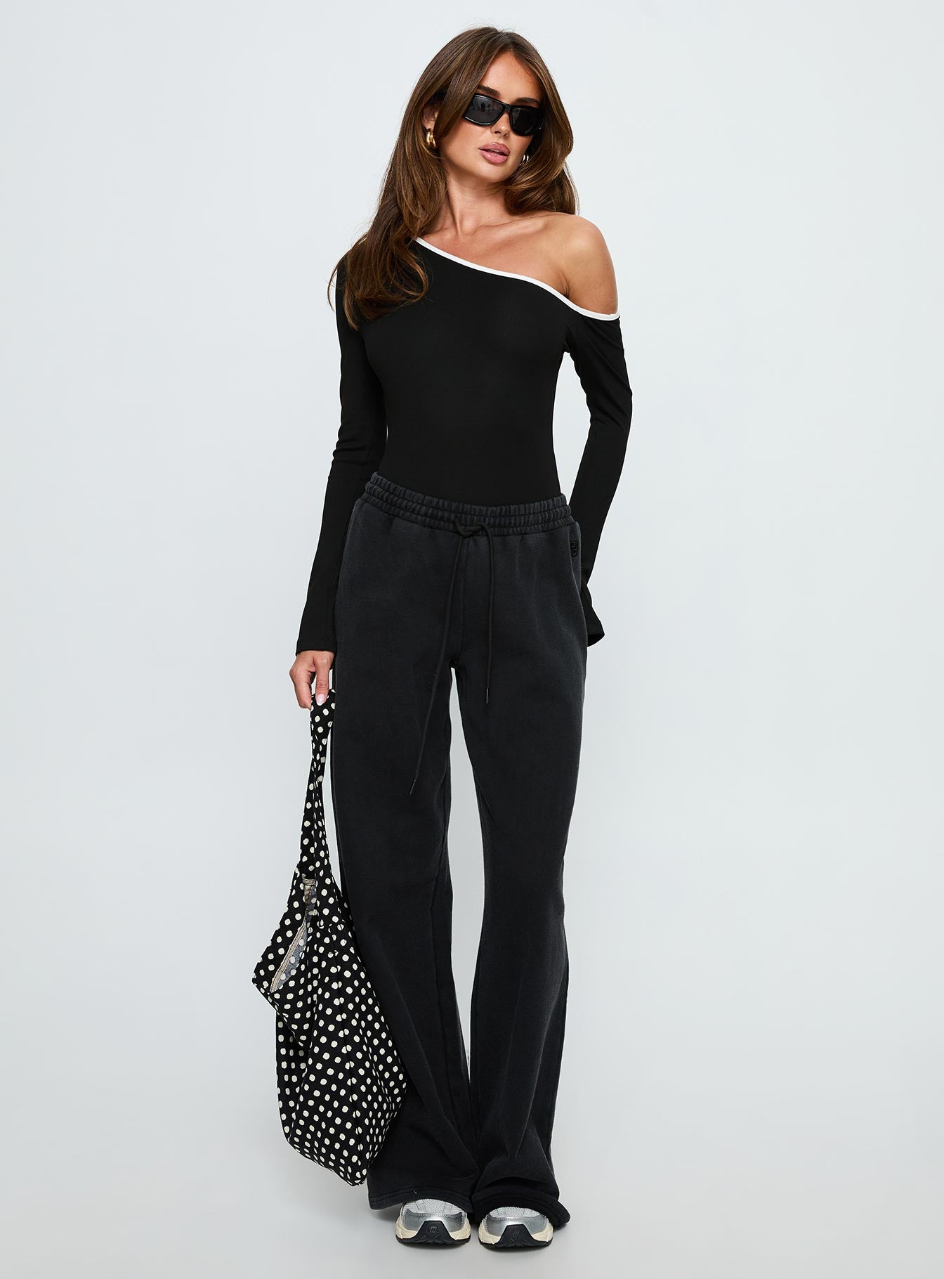 side view of model wearing Princess Polly Andrielle One Shoulder Long Sleeve Bodysuit Black / White Long Sleeve Tops 