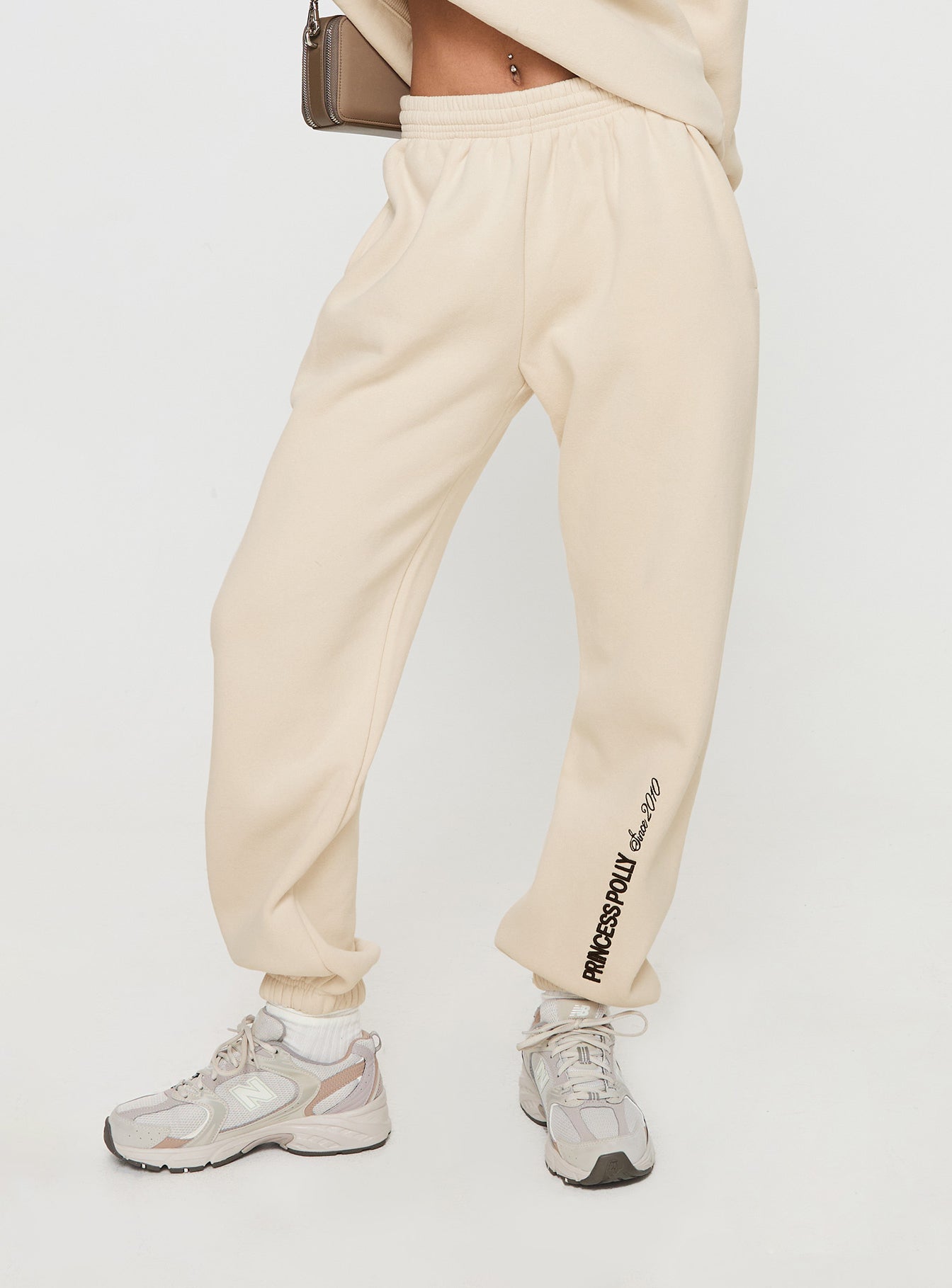 Princess polly track pants block / cursive text stone